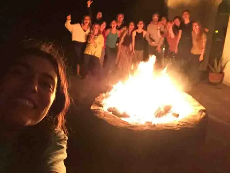 February Yoga Holiday 2027 People sitting around our firepitt on our February Yoga Holiday in 2027